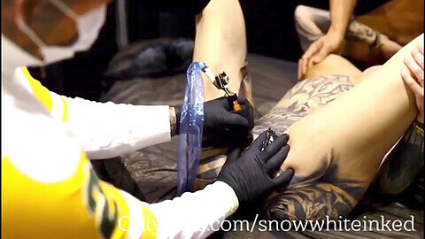 German tattooed model Snowwhite gets her asshole inked while giving double blowjobs