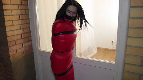 Kinky lady left outside in tight red sleeping bag, her perky plums on display