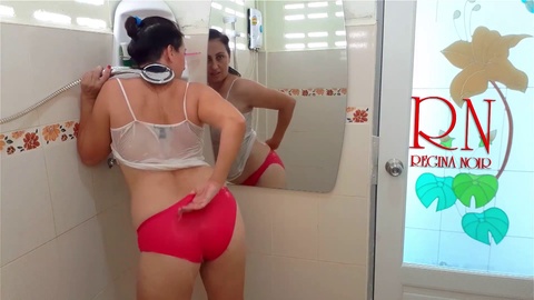College girl takes a shower in a wet t-shirt and shorts, unknowingly revealing her secrets!