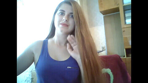 Seductive teenager with stunning, ultra-long hair teasing on webcam