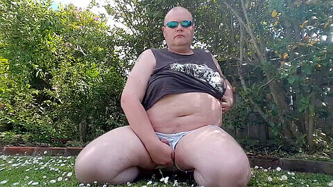 Chubby man enjoys some outdoor fun in the garden