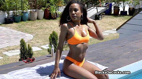 Gorgeous ebony babe in a sexy swimsuit pleasures a massive throbbing cock