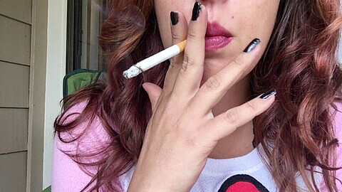 Seductive brunette babe with luscious pink lips smokes a 100mm cigarette in a fuzzy Hello Kitty shirt