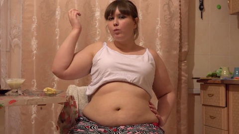 Charming BBW indulges in a delightful mukbang while showcasing her voluptuous belly