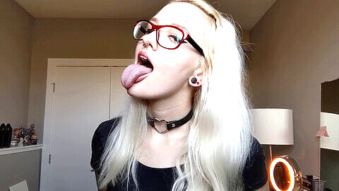 Naughty blonde slut indulges her oral fixation with long tongue, finger sucking, and slobber play