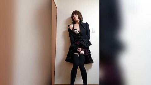 Travesti japonés en vestido gótico divirtiéndose traviesamente