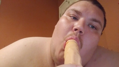 Chubby guy deepthroating a dildo