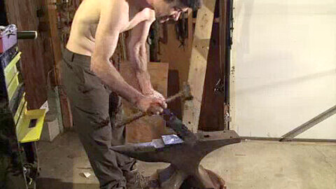 Handsome blacksmith strokes his big steel rod for your pleasure