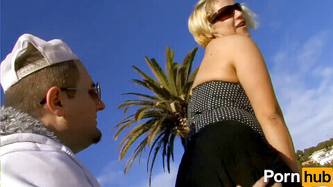 Blonde Spanish babe seduces clueless young guy on the beach