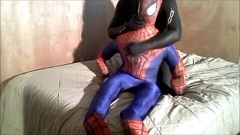 Gay guy wearing rubber Orca wetsuit masturbates on top of Spiderman while shooting his load