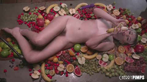 Naughty Lilly Bell indulges in a kinky food play, using fruits to please her pussy