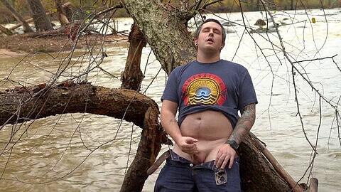 Risky public masturbation by the river - hot tattooed guy jerks off and shoots his load outdoors!