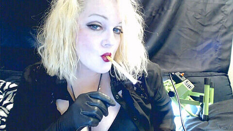 Seductive smoking mistress wearing leather gloves