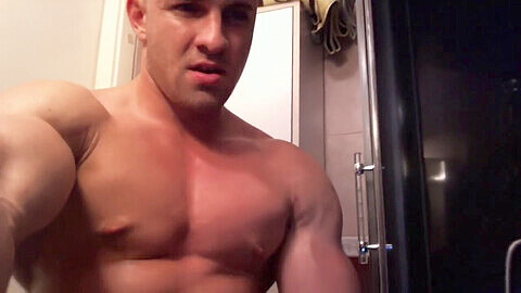 Muscular hunk showers, flexes, and shoots his load