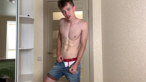 Handsome hunk teasing with his massive uncut cock in tight jeans shorts